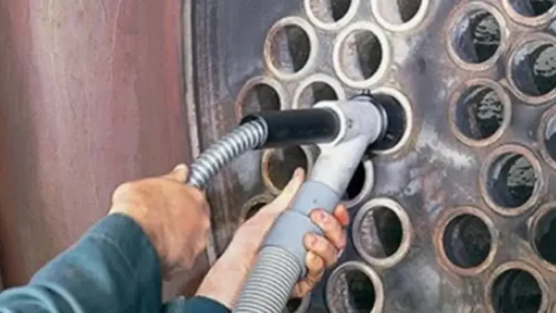 Cleaning tool inserted into boiler tube sheet